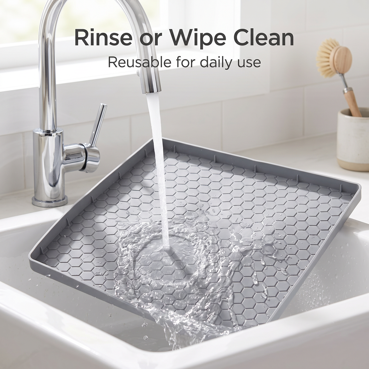 Gray pet feeding mat being rinsed with water in a sink