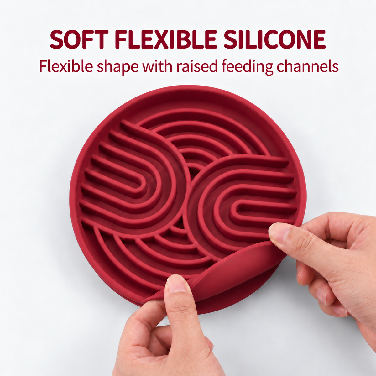 Hands bending the edge of a red silicone slow feeder bowl