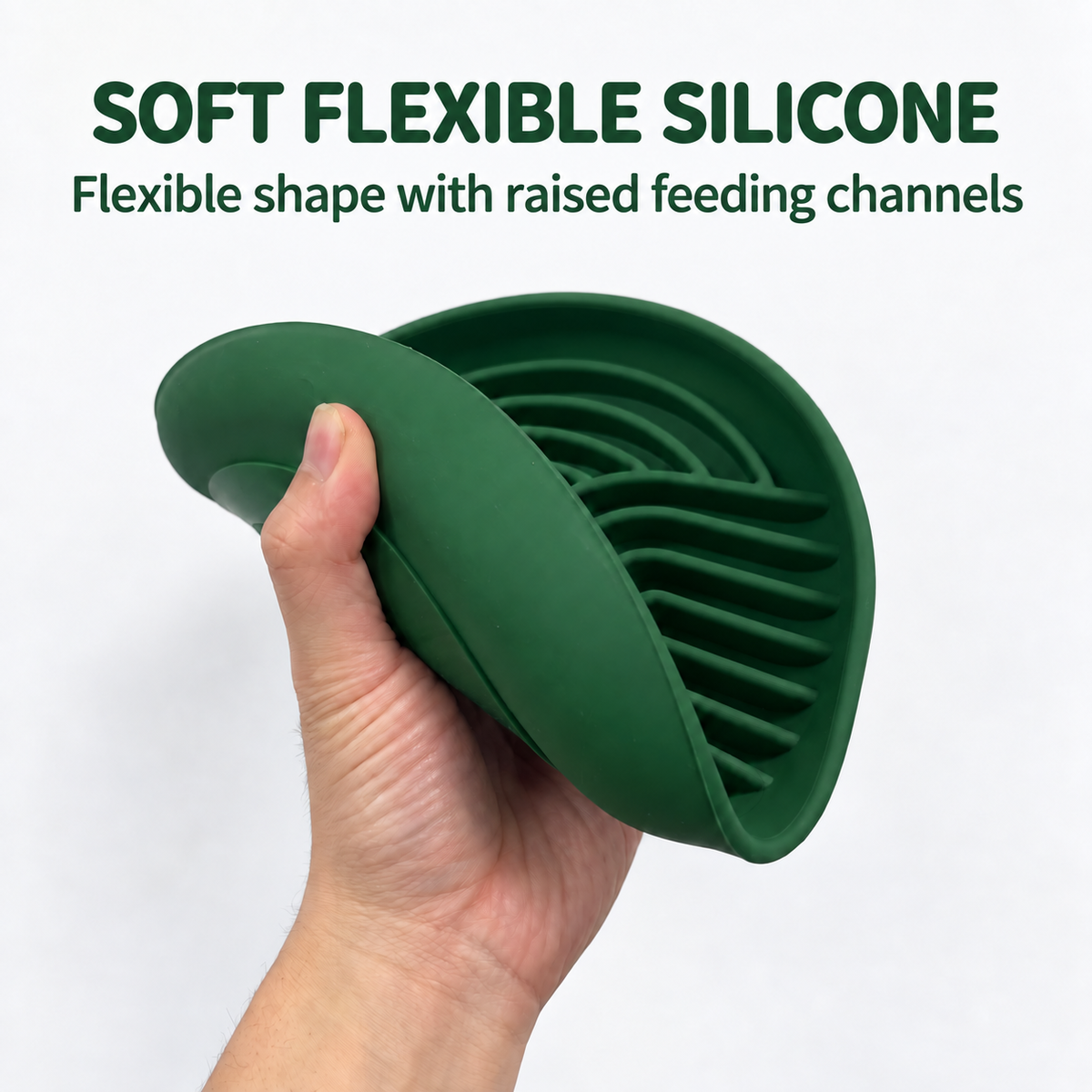 A hand bending the edge of a green silicone slow feeder bowl