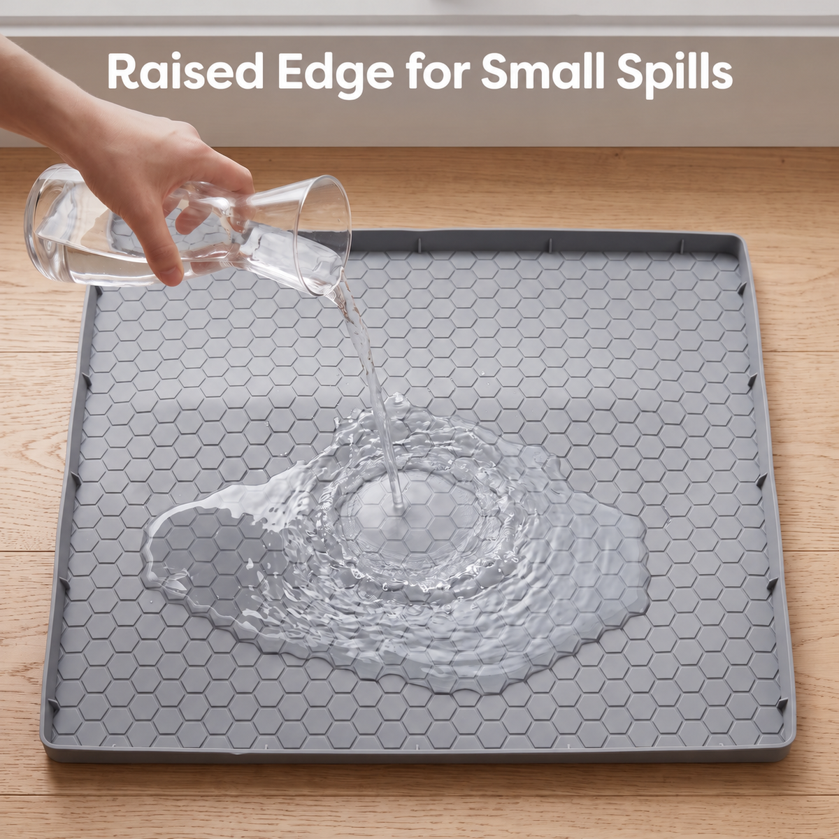 Small water spill shown inside the raised edge of a gray pet feeding mat