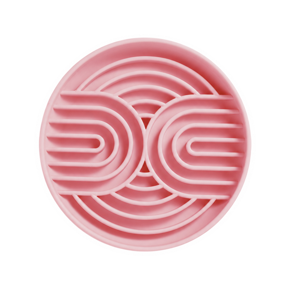 One pink silicone slow feeder bowl with curved channels on a white background