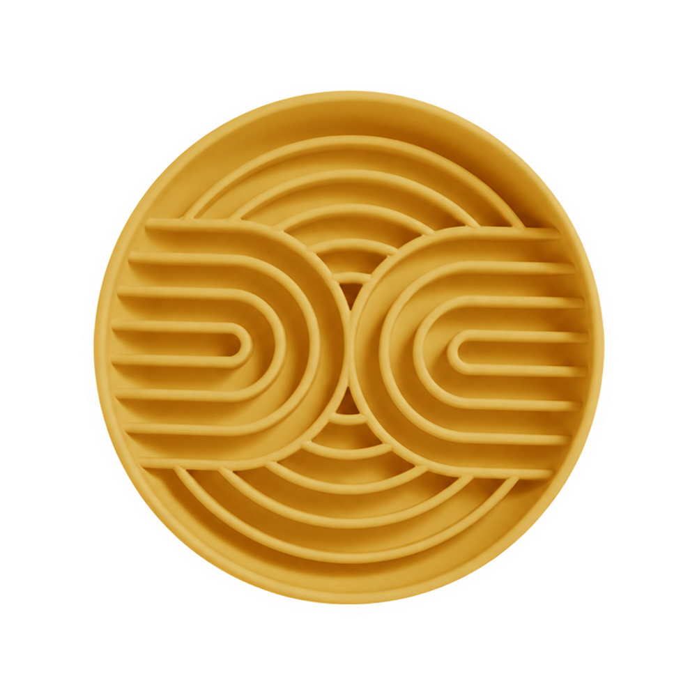One yellow silicone slow feeder bowl with curved channels on a white background