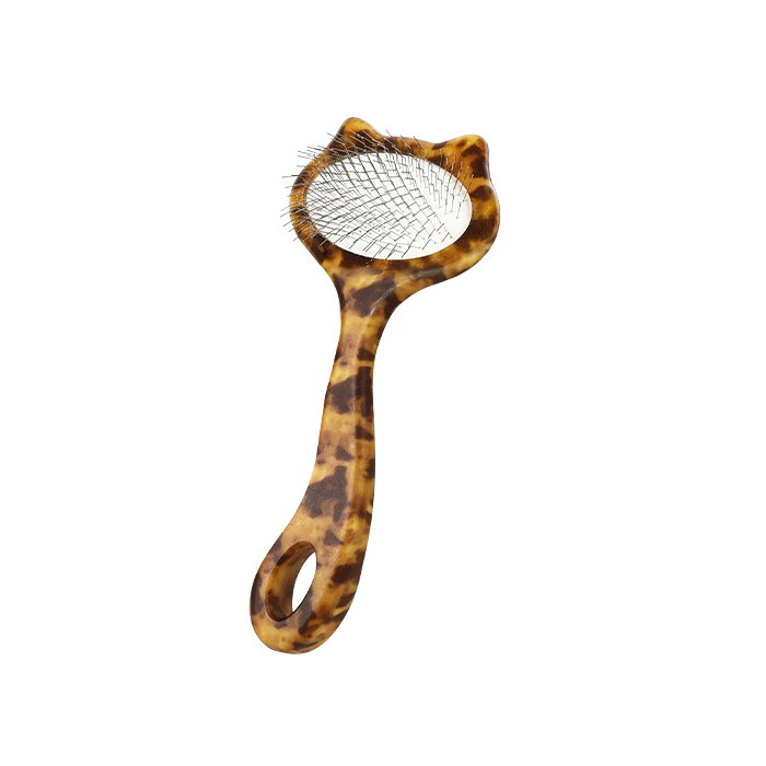 One small leopard-print cat-shaped slicker brush with metal pins on a white background