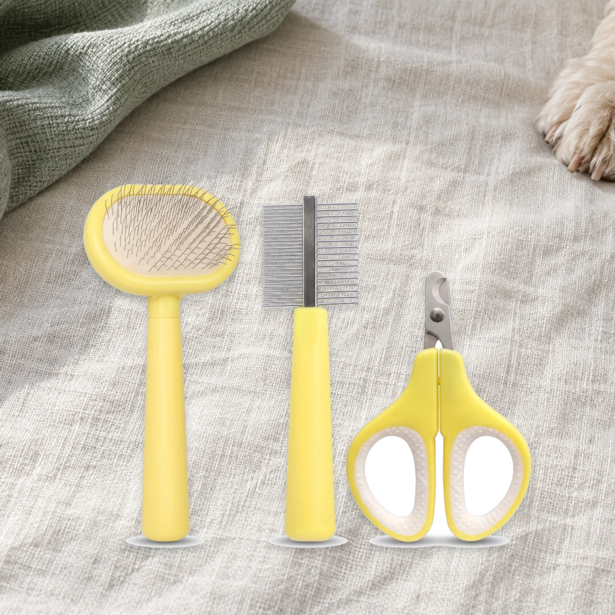 Three yellow grooming tools arranged on ivory linen