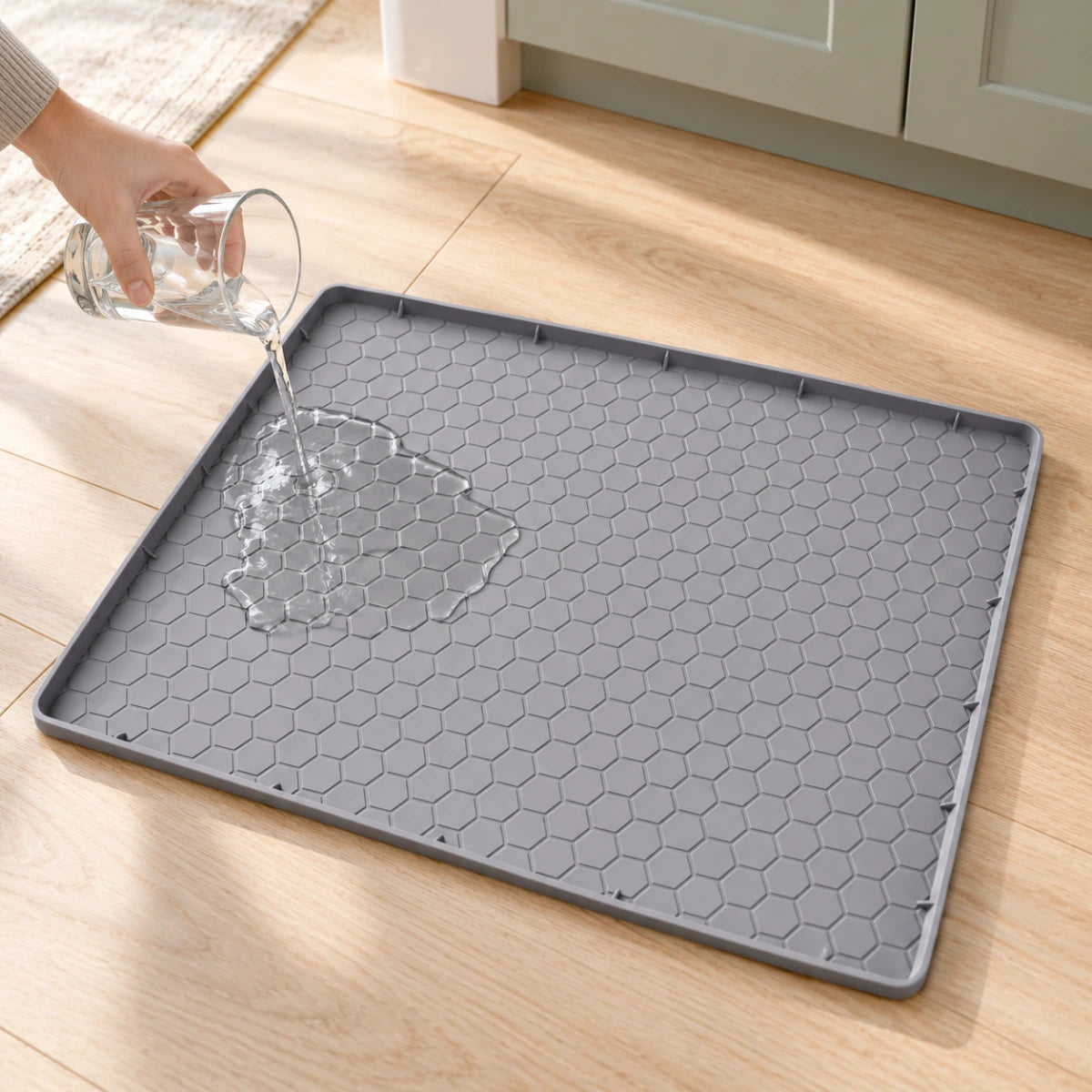 A small amount of water poured inside a grey raised-edge feeding mat